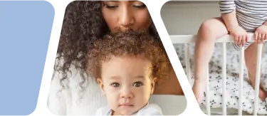 A mother kissing her baby and a toddler climbing out of a crib.